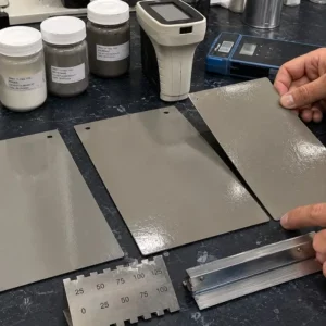 Paint QC bench with drawdown panels, grind gauge, colorimeter, and gloss meter showing dispersion-related coating defects.