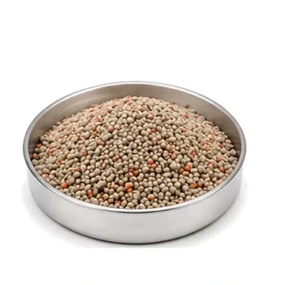 Representative granulated and blended fertilizer particles in a shallow stainless steel sample dish