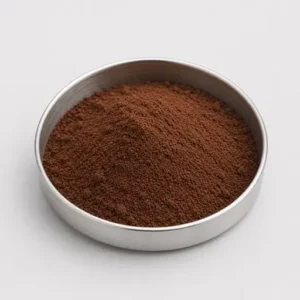 Dark brown cocoa or coffee powder in a stainless steel sample dish