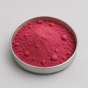Pink-red dehydrated fruit powder in a stainless steel sample dish