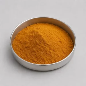 Orange spice or seasoning powder in a stainless steel sample dish