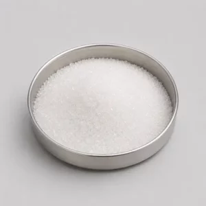 White crystalline food ingredient in a stainless steel sample dish