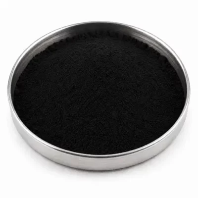 Fine carbon black pigment powder in a stainless steel sample dish