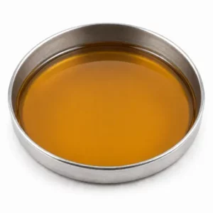 Amber liquid wetting and dispersant additive in a shallow stainless steel sample dish