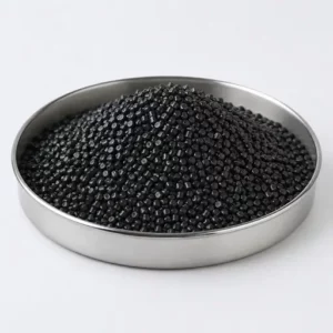 Black masterbatch pellets in a stainless steel sample dish