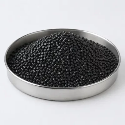Black masterbatch and additive concentrate pellets in a stainless steel sample dish