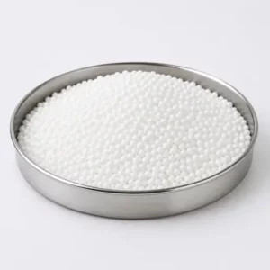 White expandable polymer beads in a stainless steel sample dish