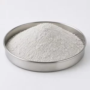 Fine light-grey mineral filler powder in a stainless steel sample dish