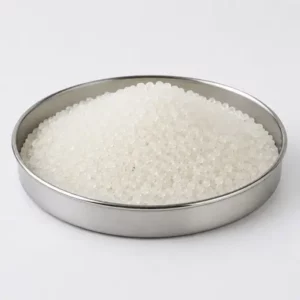 Translucent virgin polymer pellets in a stainless steel sample dish