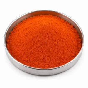 Orange rubber additive powder in a shallow stainless steel sample dish