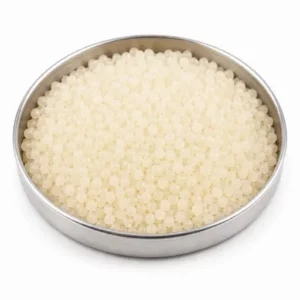 Synthetic rubber pellets in a shallow stainless steel dish