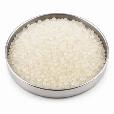 Thermoplastic elastomer pellets in a stainless steel sample dish